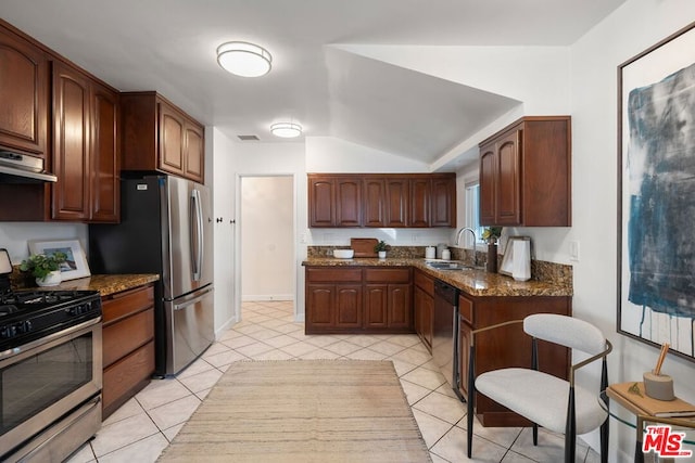 kitchen with extractor fan, appliances with stainless steel finishes, sink, and dark stone countertops