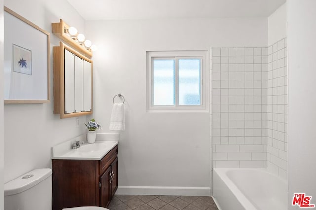 full bathroom with tile patterned floors, vanity, toilet, and tiled shower / bath