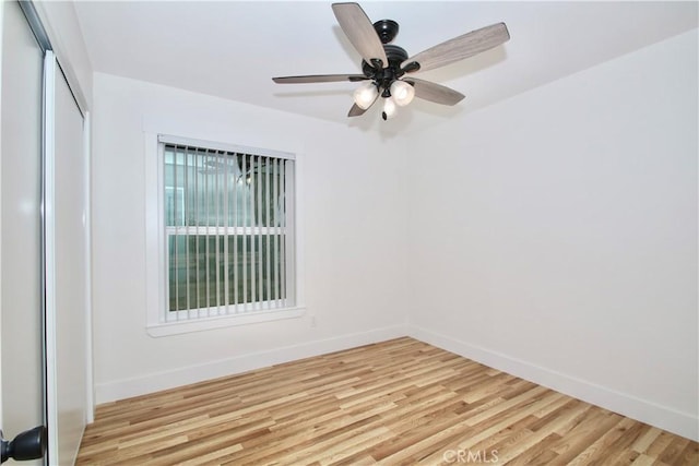 empty room with light hardwood / wood-style flooring and ceiling fan