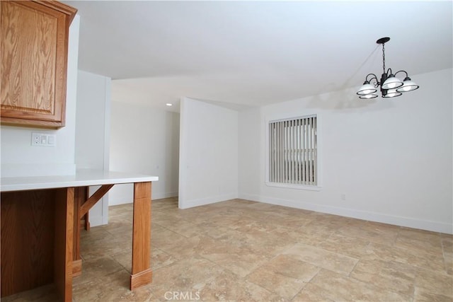 unfurnished dining area with a chandelier