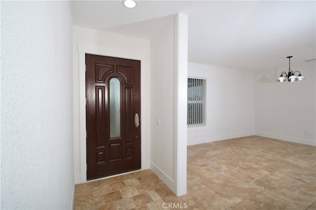 entryway with an inviting chandelier