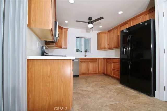 kitchen featuring sink, stainless steel dishwasher, ceiling fan, and black refrigerator with ice dispenser