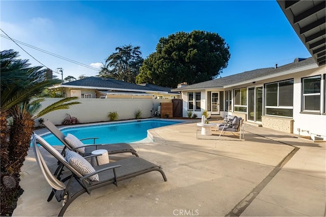 view of pool with a fenced in pool, fence, and a patio