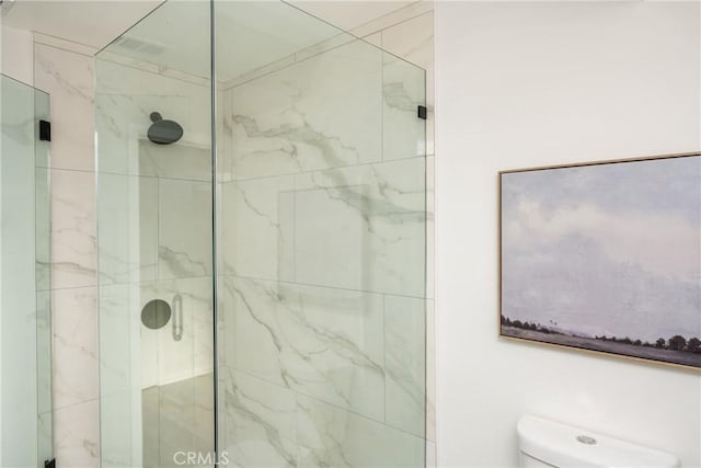 full bath featuring toilet and a shower stall