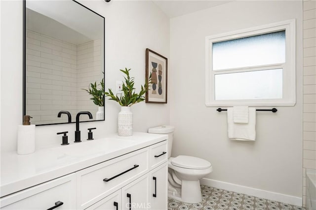 full bath featuring vanity, toilet, and baseboards