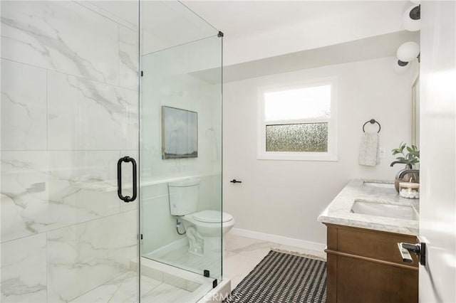 full bathroom featuring marble finish floor, double vanity, toilet, a shower stall, and baseboards