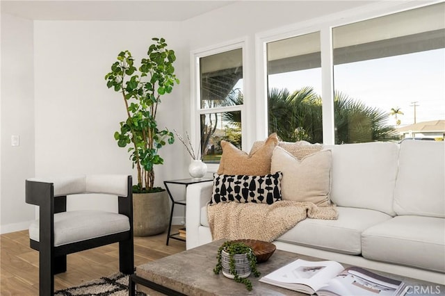 living room with light wood-style flooring and baseboards