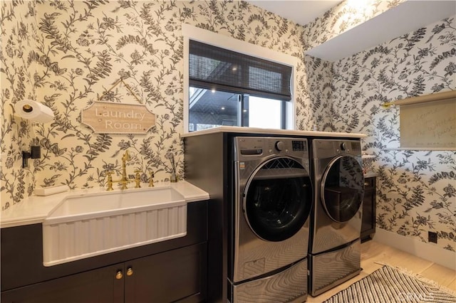 washroom with baseboards, washer and clothes dryer, wood finished floors, and wallpapered walls