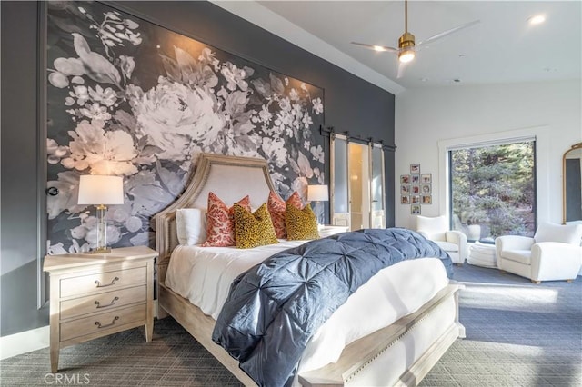 bedroom with vaulted ceiling, carpet floors, a barn door, and ceiling fan