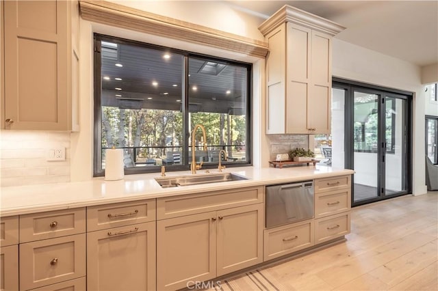 kitchen with light wood-style floors, light countertops, a sink, and a warming drawer