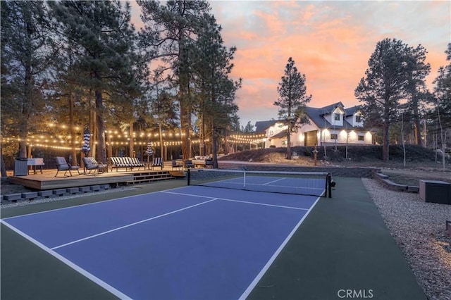 view of tennis court with a wooden deck