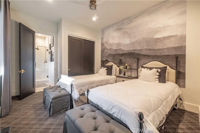 bedroom with baseboards, dark colored carpet, a closet, and ensuite bathroom