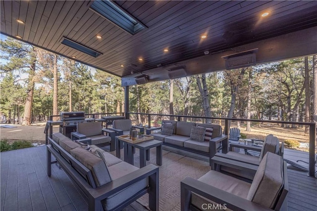 view of patio / terrace with area for grilling, an outdoor living space, and a wooden deck