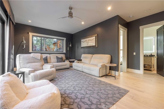 living room with a ceiling fan, light wood-type flooring, baseboards, and recessed lighting