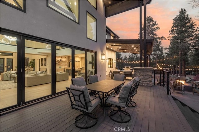 wooden terrace featuring outdoor dining area and an outdoor living space