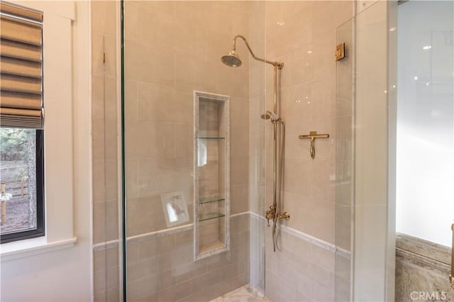 bathroom with a tile shower