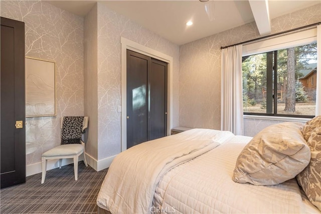 bedroom with wallpapered walls, baseboards, dark colored carpet, beam ceiling, and recessed lighting