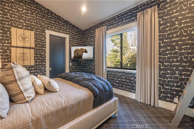 bedroom with carpet floors, baseboards, and vaulted ceiling