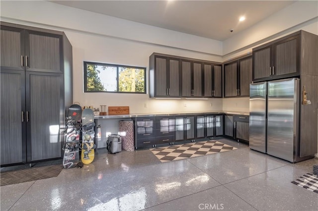 kitchen with light speckled floor, freestanding refrigerator, dark brown cabinets, and recessed lighting