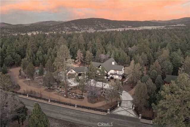 aerial view at dusk with a forest view and a mountain view