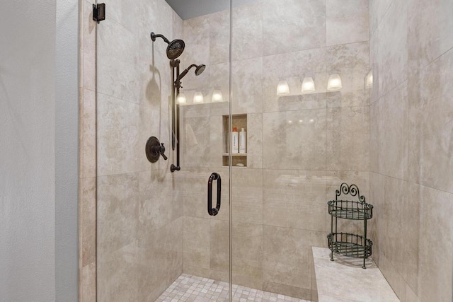 bathroom featuring a shower with door