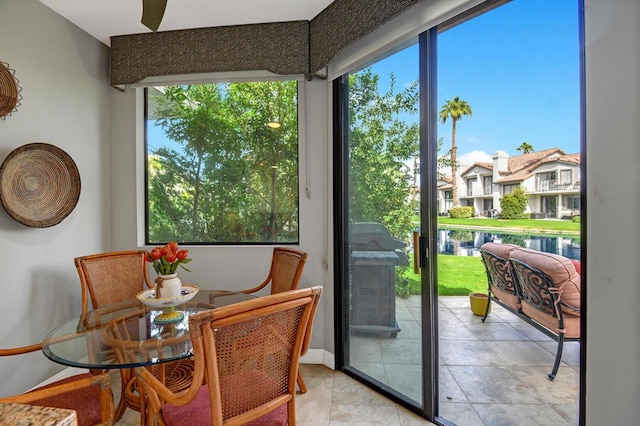 sunroom / solarium featuring a water view