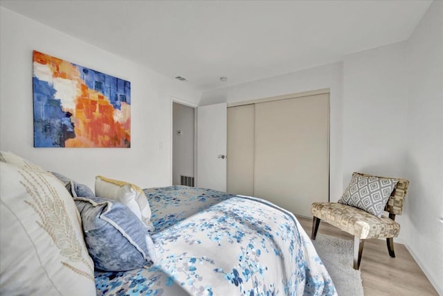 bedroom featuring light hardwood / wood-style flooring and a closet