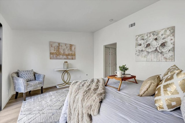 bedroom featuring light hardwood / wood-style floors and a closet