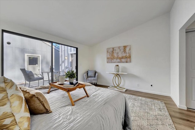 bedroom with hardwood / wood-style flooring and vaulted ceiling