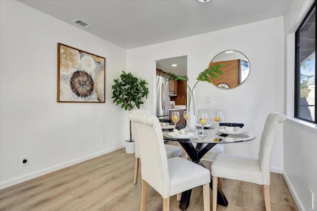 dining space featuring light wood-type flooring