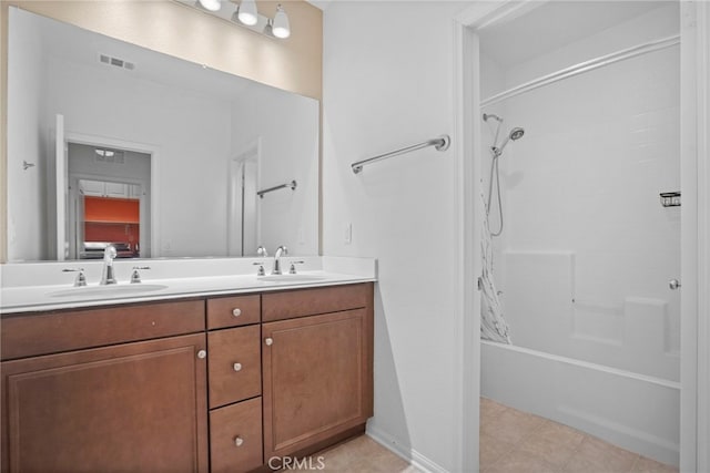 bathroom with tile patterned floors, vanity, and bathing tub / shower combination