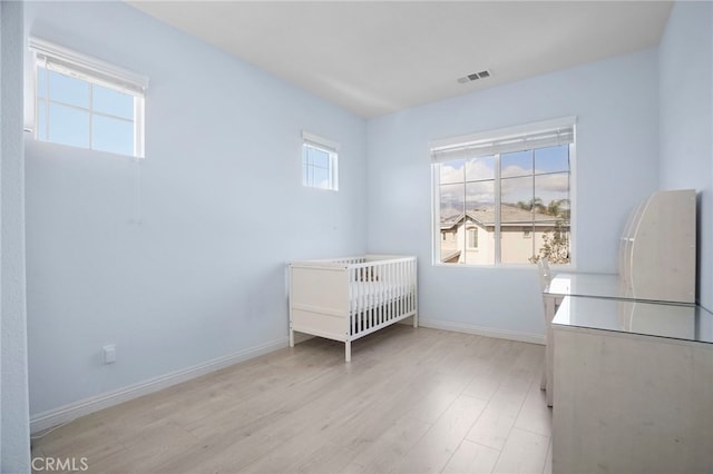 unfurnished bedroom with light wood-type flooring