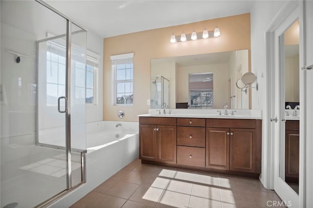 bathroom with independent shower and bath, vanity, and tile patterned floors