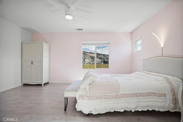 bedroom featuring light hardwood / wood-style floors and ceiling fan