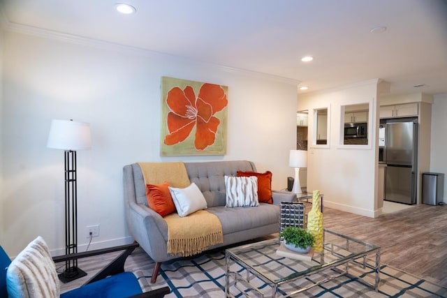 living room with crown molding and hardwood / wood-style floors