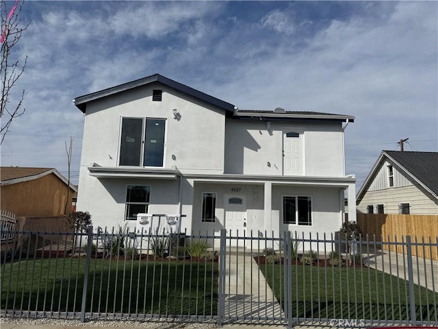 view of front of home with covered porch, a front lawn, a fenced front yard, and stucco siding