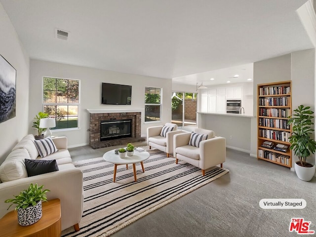 living room with a brick fireplace and light colored carpet