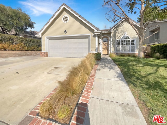 single story home with a garage and a front yard