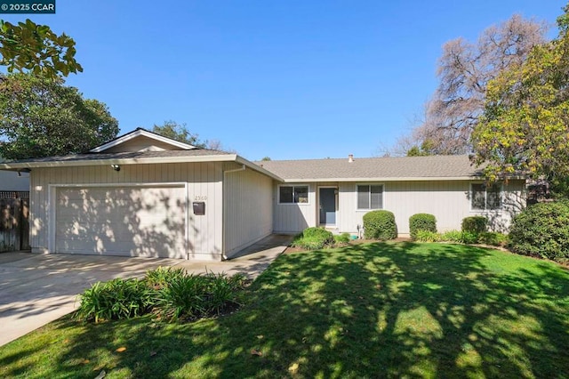 ranch-style house with a garage and a front lawn