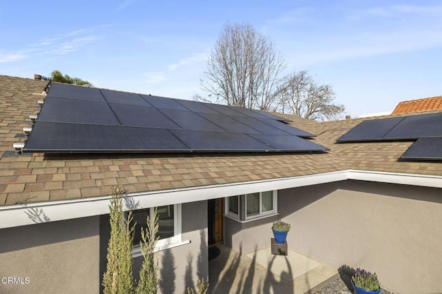 view of side of property with solar panels