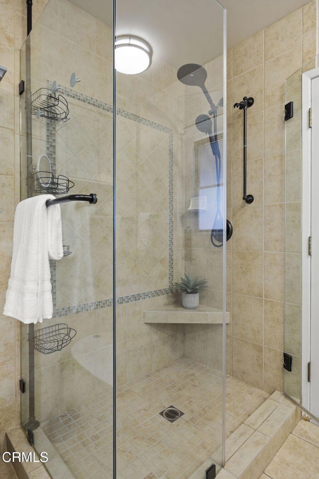 bathroom with a shower with door