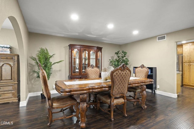 dining space with dark hardwood / wood-style flooring