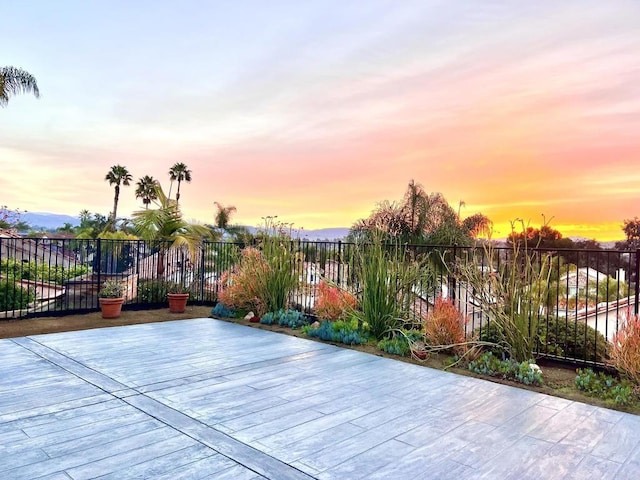 patio terrace at dusk featuring a deck