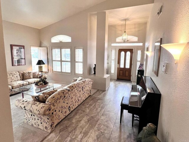 living room with high vaulted ceiling