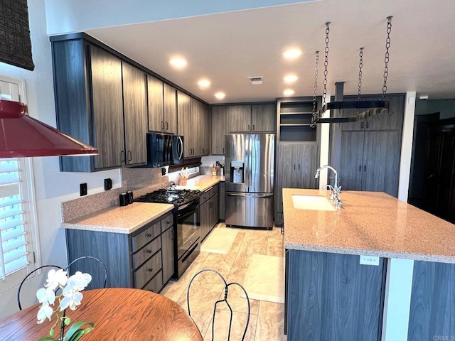 kitchen featuring light stone counters, stainless steel appliances, sink, and dark brown cabinets