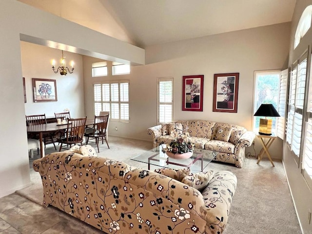 living room with lofted ceiling, light colored carpet, and an inviting chandelier