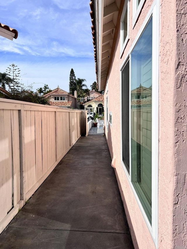 view of home's exterior with fence and stucco siding