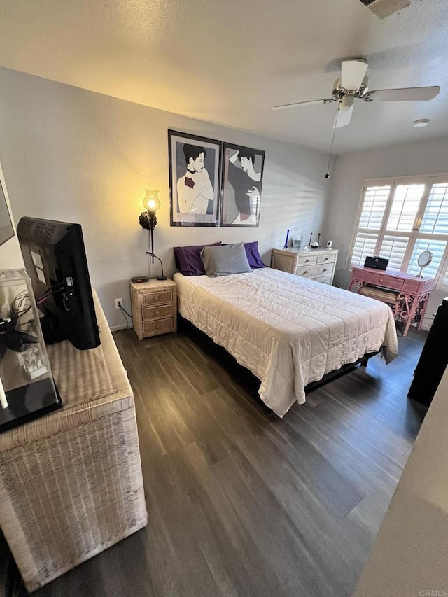 bedroom with ceiling fan and dark wood finished floors