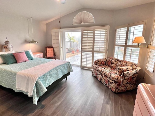 bedroom with access to exterior, wood finished floors, and lofted ceiling