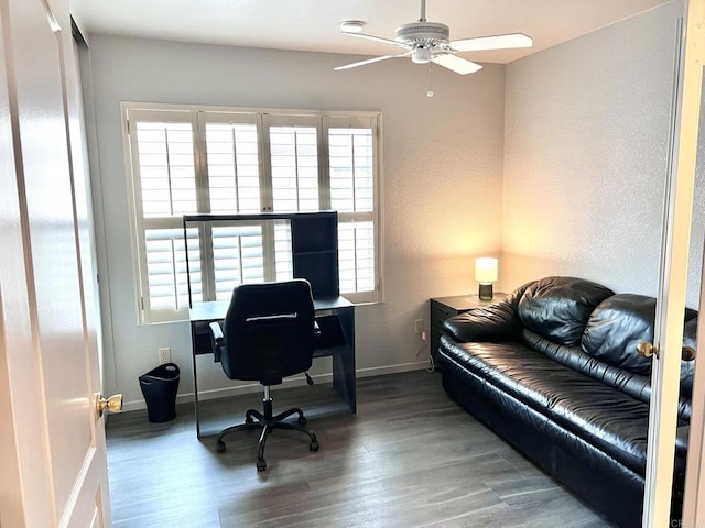 office area featuring wood finished floors, baseboards, a textured wall, and ceiling fan